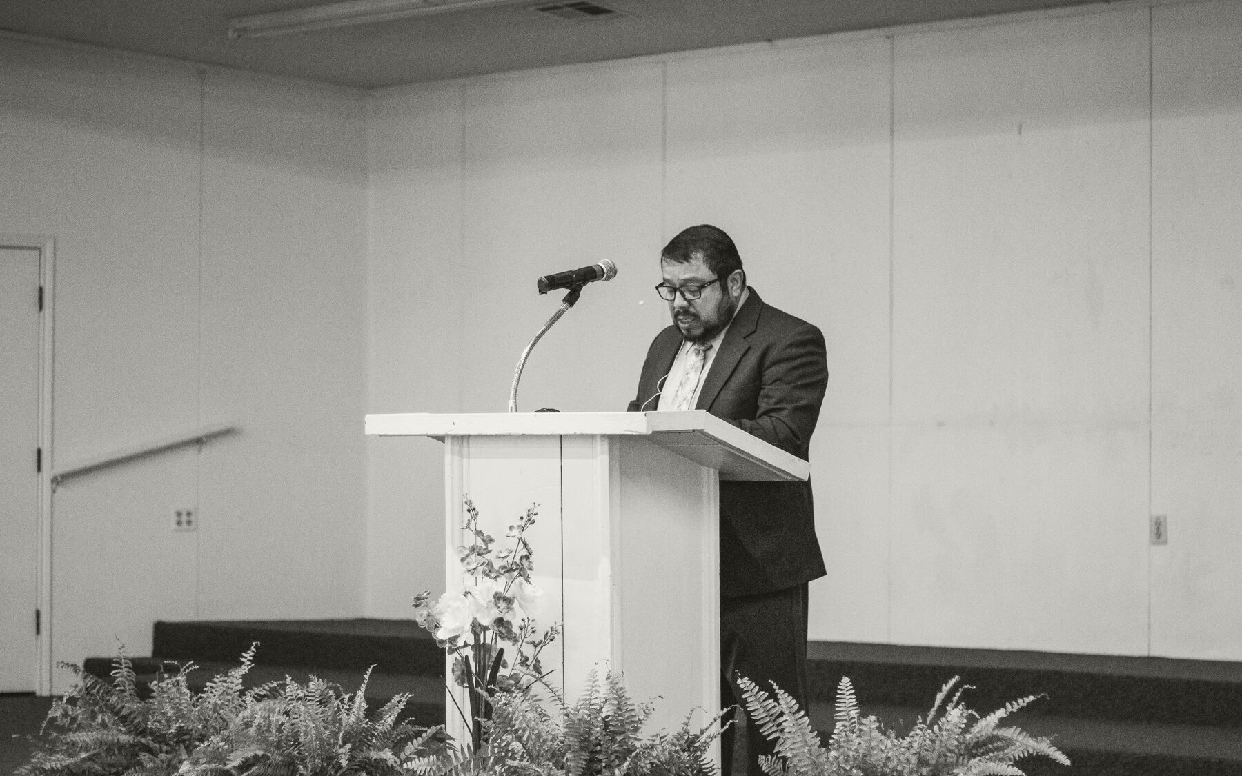 A preacher speaking from a simple podium during one of the sessions.